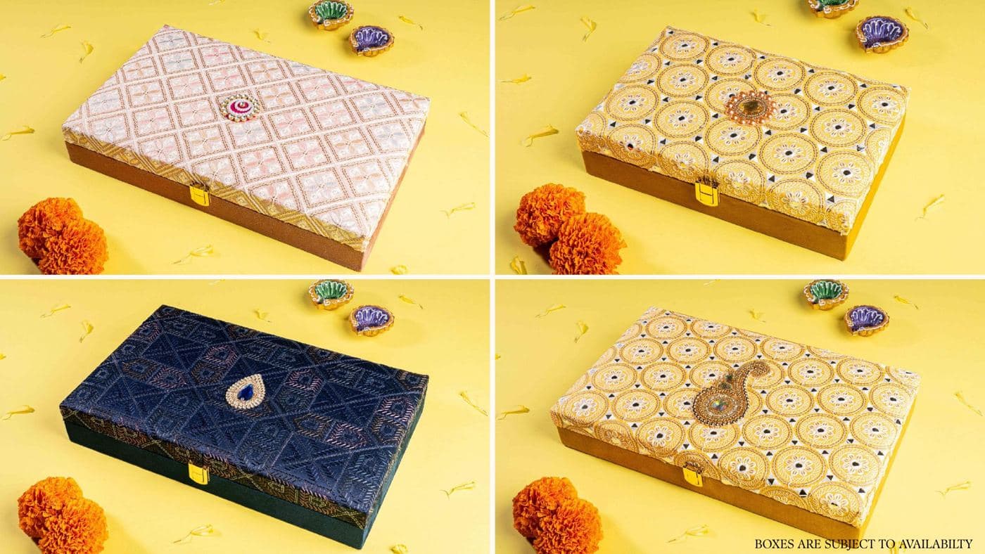 Four embroidered Chhappan Bhog gift boxes with brass clasps and jewelled brooches