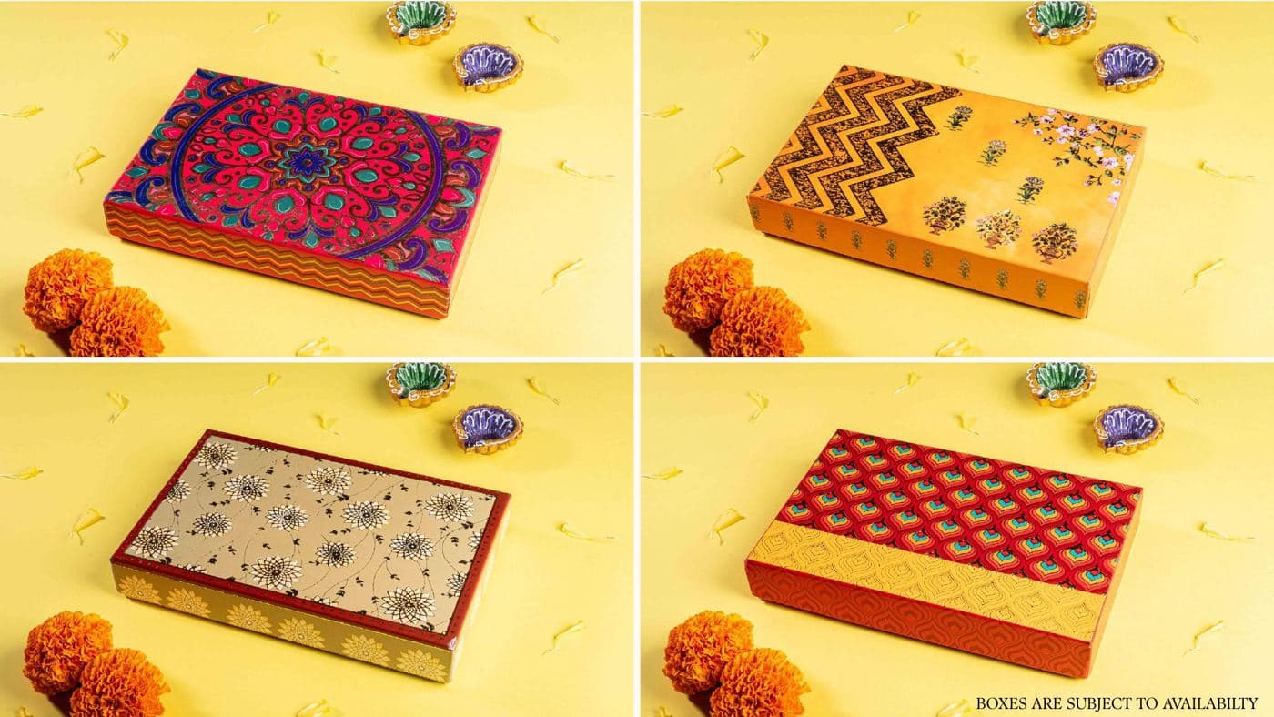 Four printed Chhappan Bhog gift boxes in mandala, floral and peacock patterns