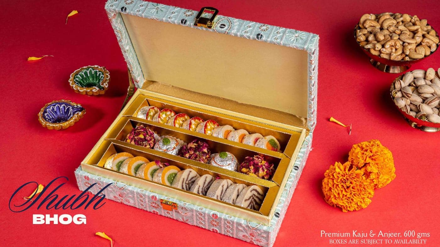 The Shubh Bhog box from Chhappan Bhog, an embroidered case open to show kaju and anjeer sweets