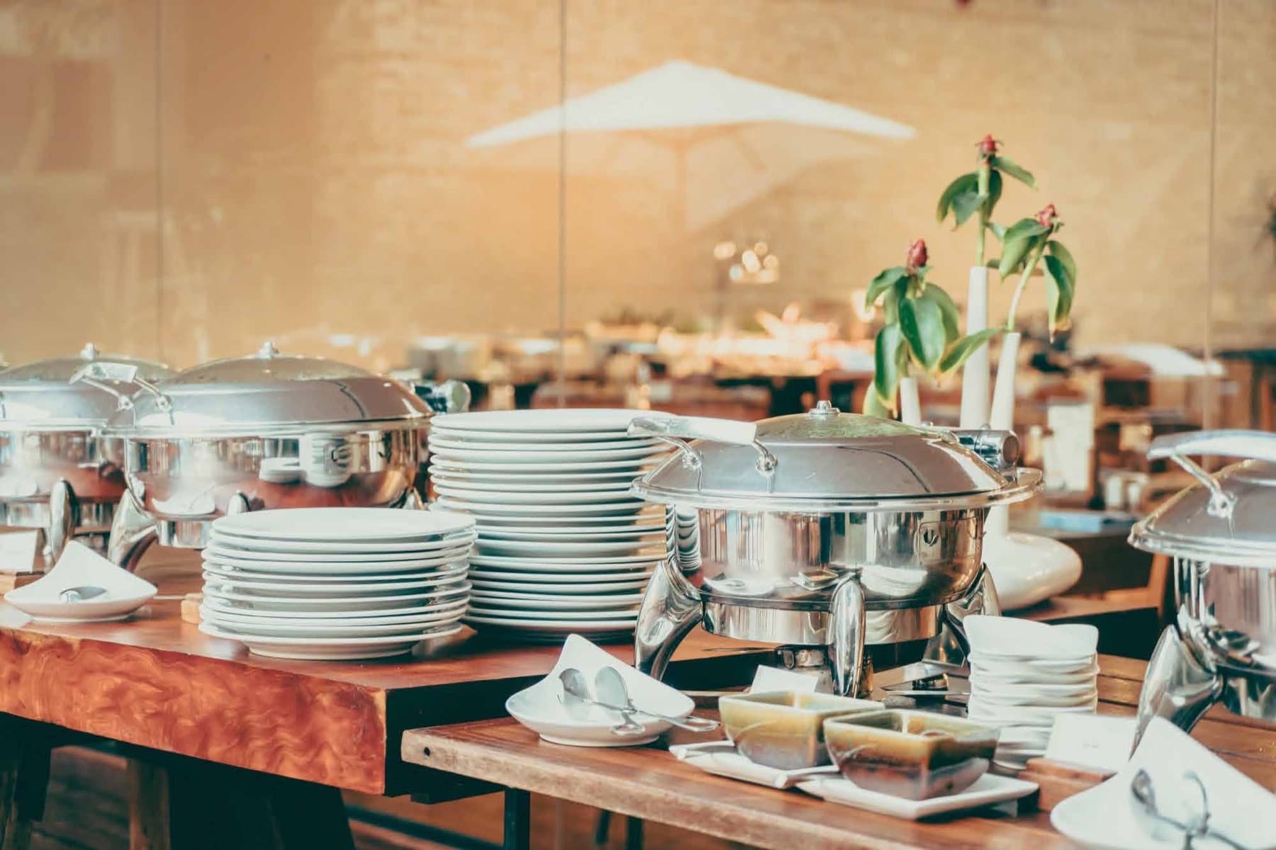 A polished buffet line of chafing dishes set up by Cater Inc.