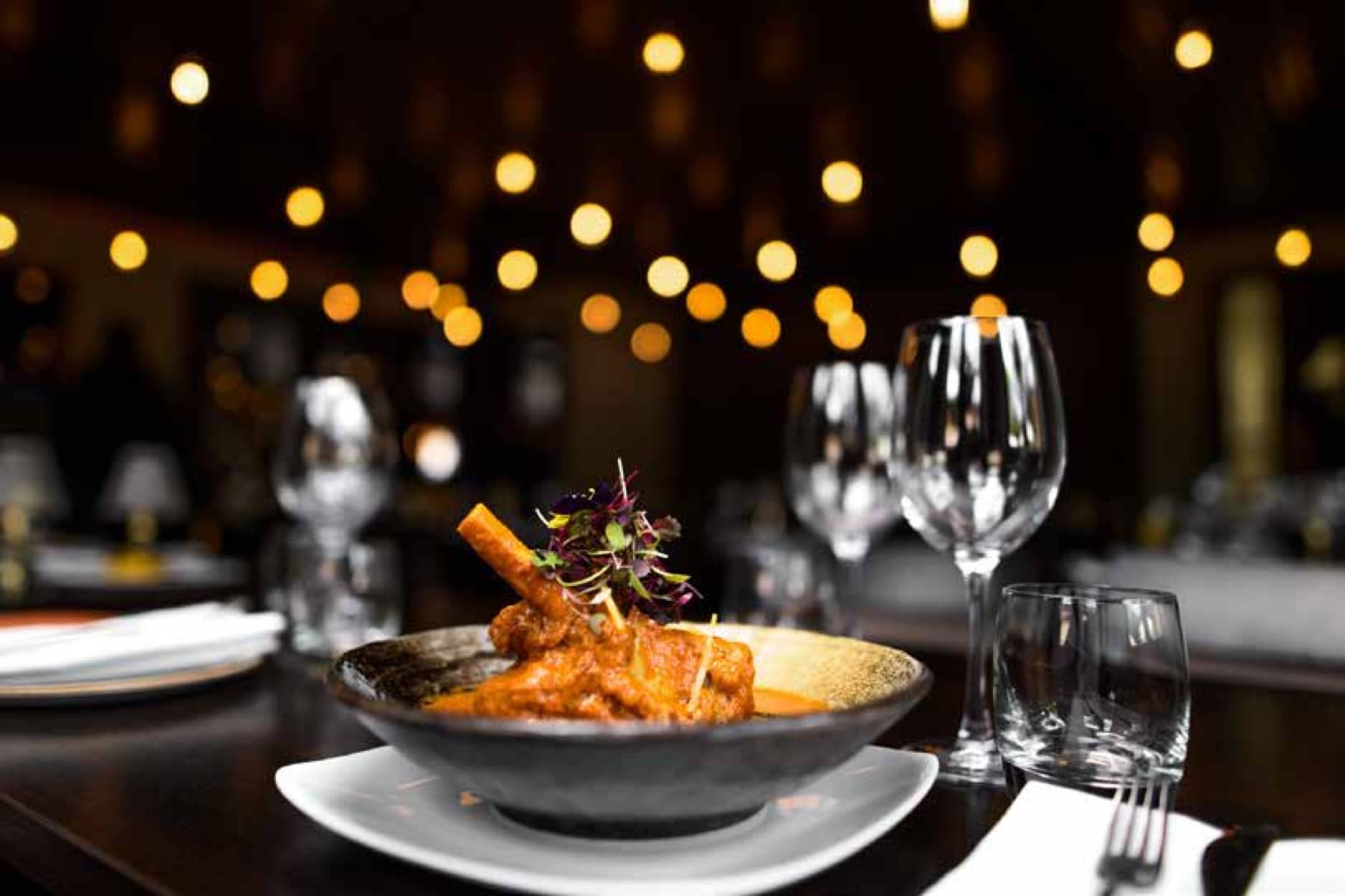 A dark, richly styled Indian dinner spread by Cater Inc.